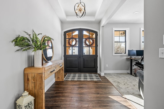 2451 180th Ln NE, Ham Lake, MN 55304 - entrance foyer with an inviting chandelier, a raised ceiling, french doors, baseboards, and wood finished floors
