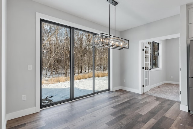 2451 180th Ln NE, Ham Lake, MN 55304 - unfurnished dining area with baseboards, dark wood finished floors, and a notable chandelier