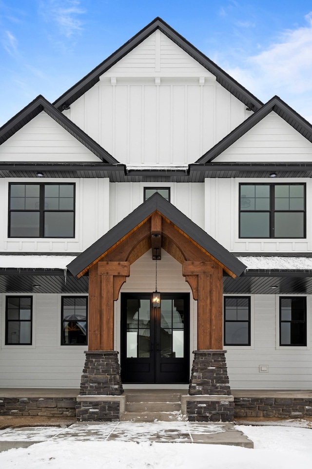 exterior space with board and batten siding and french doors