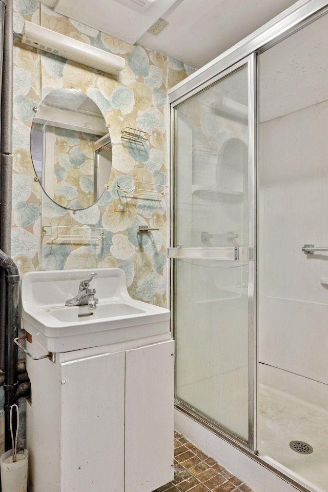 full bathroom with vanity, brick floor, and a shower stall