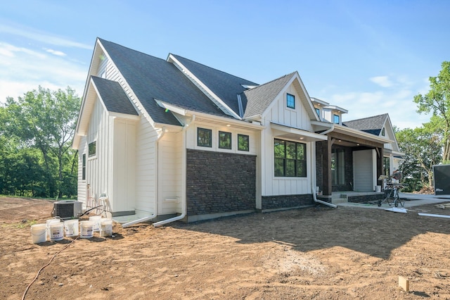 2475 179th Ave NE, Ham Lake, MN 55304 - view of front of property with roof with shingles, board and batten siding, central AC, and a patio area
