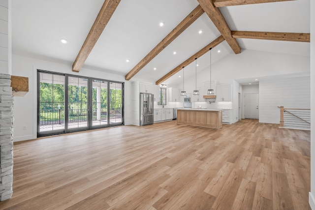 2475 179th Ave NE, Ham Lake, MN 55304 - unfurnished living room featuring high vaulted ceiling, beamed ceiling, recessed lighting, and light wood-style flooring