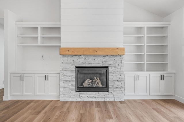2475 179th Ave NE, Ham Lake, MN 55304 - unfurnished living room featuring a fireplace, vaulted ceiling, and light wood finished floors