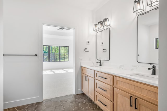 2475 179th Ave NE, Ham Lake, MN 55304 - full bath featuring baseboards, double vanity, tile patterned floors, and a sink