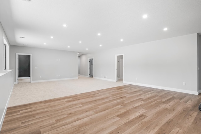 2475 179th Ave NE, Ham Lake, MN 55304 - unfurnished living room featuring recessed lighting, baseboards, visible vents, and light wood-style floors