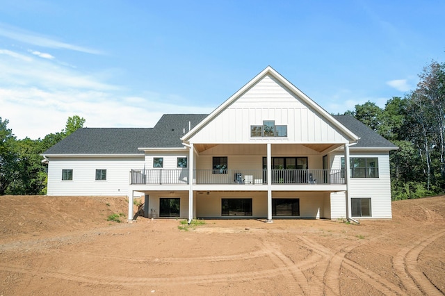 2475 179th Ave NE, Ham Lake, MN 55304 - back of property with roof with shingles, board and batten siding, driveway, and a balcony
