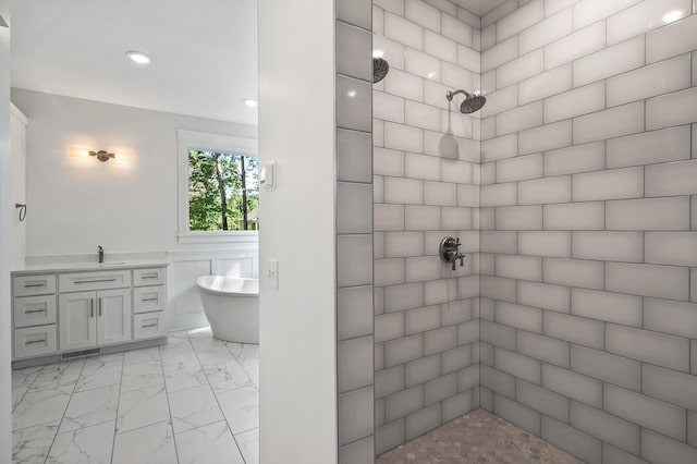 full bath featuring visible vents, vanity, marble finish floor, a soaking tub, and tiled shower