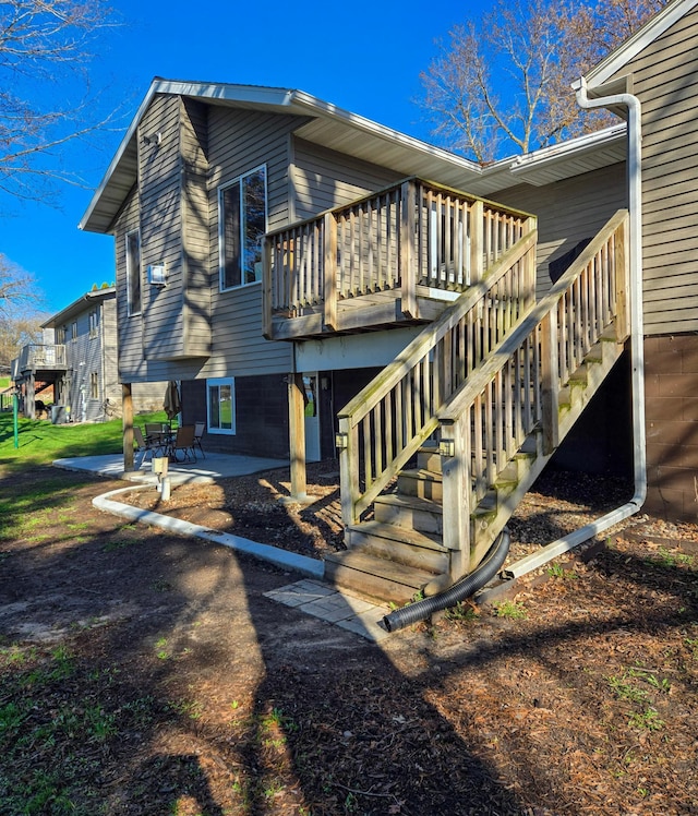rear view of property with a patio, stairs, and a deck