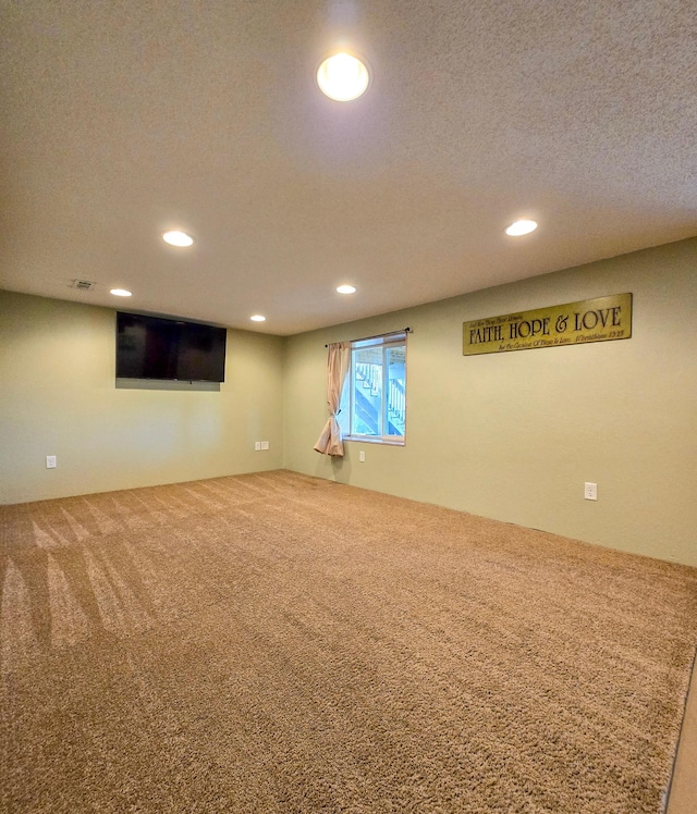 below grade area featuring recessed lighting, carpet flooring, and a textured ceiling