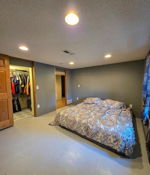 carpeted bedroom featuring visible vents, recessed lighting, and a textured ceiling