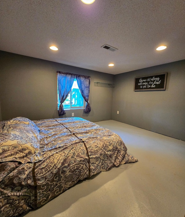 bedroom featuring recessed lighting, a textured ceiling, and visible vents