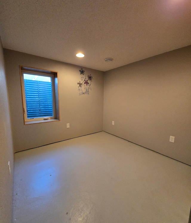 spare room with recessed lighting and a textured ceiling