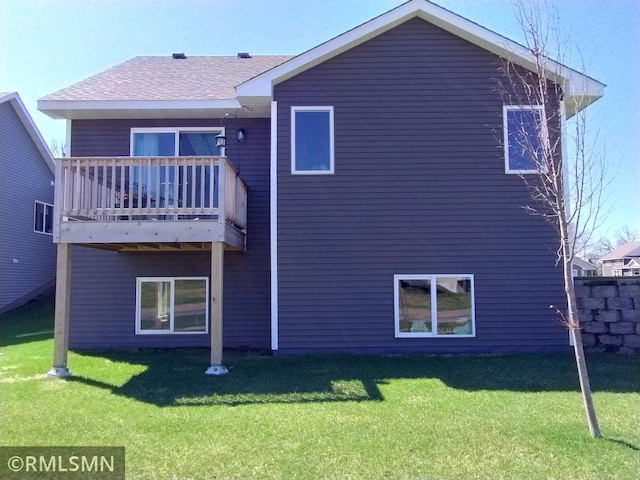 rear view of property with a lawn