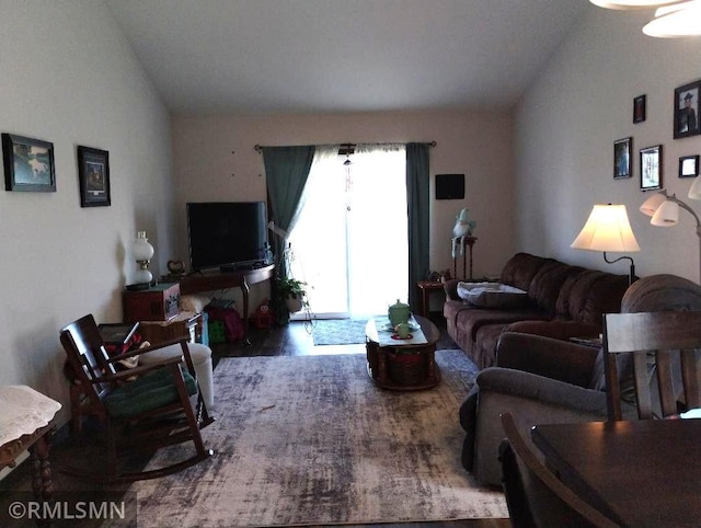 living area featuring wood finished floors and lofted ceiling