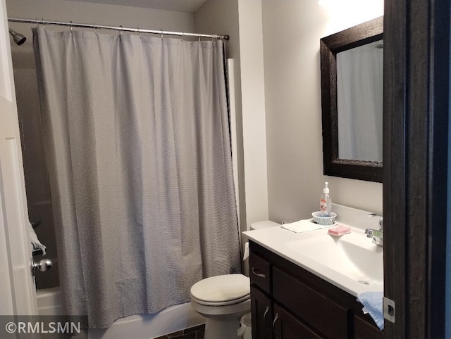 full bath with vanity, shower / bath combo, and toilet