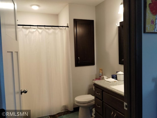 bathroom featuring vanity, toilet, and a shower with curtain