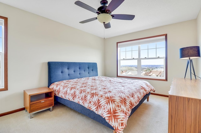 bedroom with baseboards, a ceiling fan, and carpet flooring