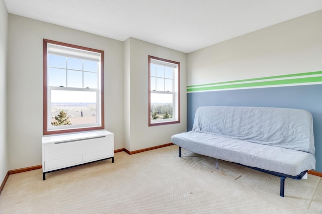 sitting room featuring carpet flooring and baseboards