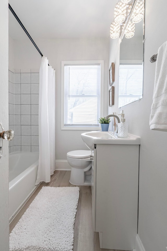 full bathroom with vanity, toilet, shower / bathtub combination with curtain, baseboards, and wood finished floors