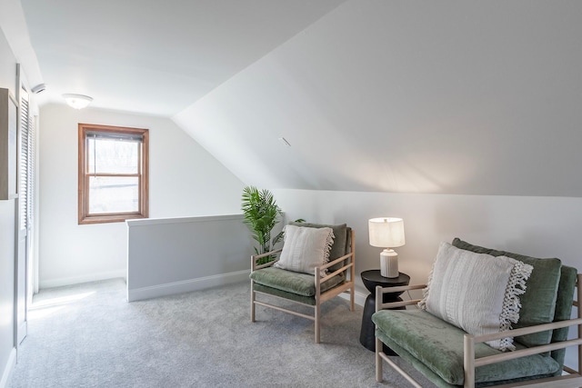 sitting room with carpet flooring, baseboards, and lofted ceiling
