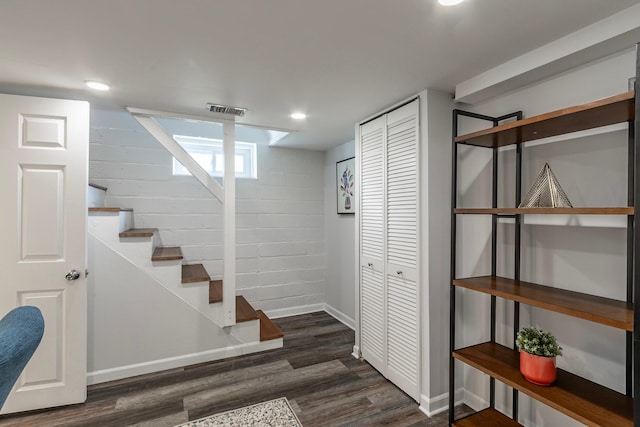 below grade area with recessed lighting, baseboards, wood finished floors, visible vents, and stairway
