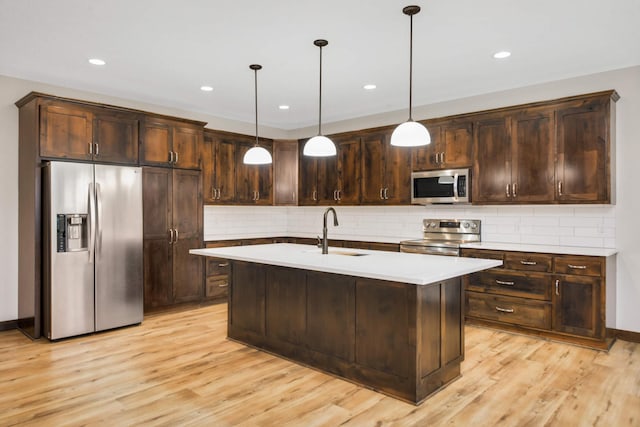 12891 Xylite St NE, Blaine, MN 55449 - kitchen with a sink, dark brown cabinetry, and stainless steel appliances