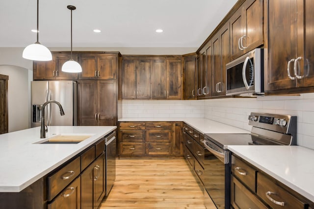 12891 Xylite St NE, Blaine, MN 55449 - kitchen with light countertops, stainless steel appliances, and a sink