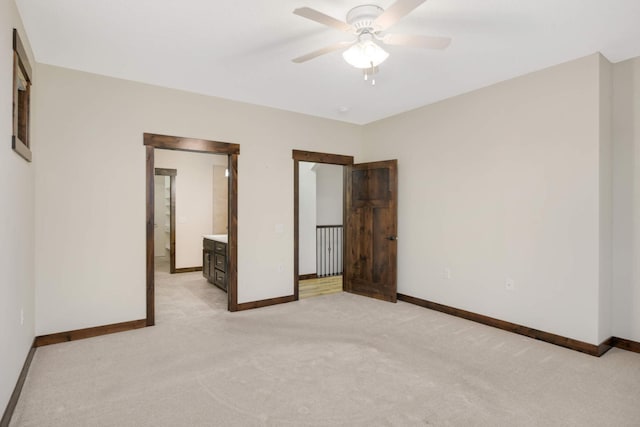 12891 Xylite St NE, Blaine, MN 55449 - unfurnished bedroom with baseboards, ceiling fan, and light colored carpet