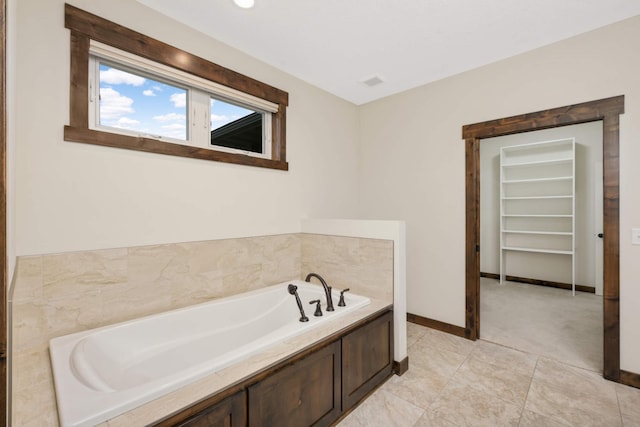 12891 Xylite St NE, Blaine, MN 55449 - full bath featuring baseboards, a garden tub, and a spacious closet