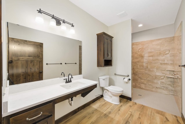 12891 Xylite St NE, Blaine, MN 55449 - full bathroom featuring vanity, walk in shower, wood finished floors, and toilet