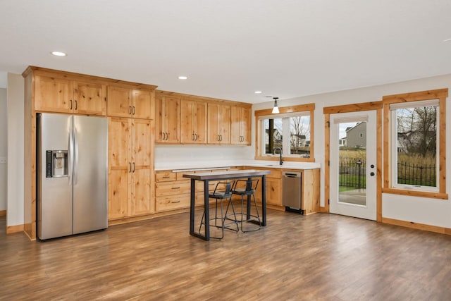 12891 Xylite St NE, Blaine, MN 55449 - kitchen with light countertops, stainless steel appliances, recessed lighting, and dark wood finished floors