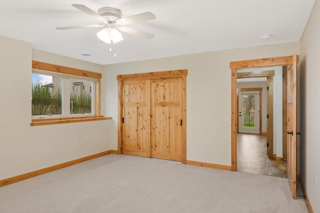 12891 Xylite St NE, Blaine, MN 55449 - unfurnished bedroom featuring baseboards, carpet flooring, ceiling fan, and a closet