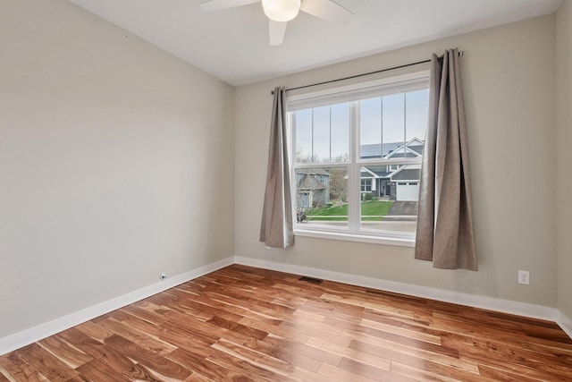 5743 Meridian Way NE, Prior Lake, MN 55372 - spare room featuring wood finished floors, ceiling fan, and baseboards