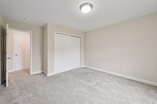5743 Meridian Way NE, Prior Lake, MN 55372 - unfurnished bedroom with carpet floors, baseboards, a closet, and a textured ceiling