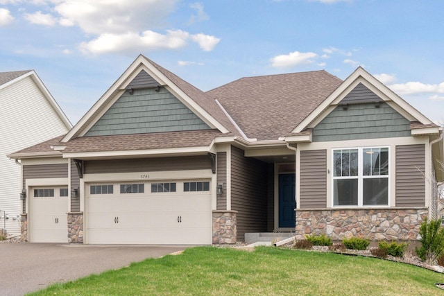 5743 Meridian Way NE, Prior Lake, MN 55372 - craftsman-style home with a garage, stone siding, a shingled roof, and driveway