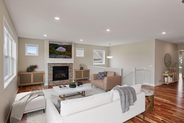 5743 Meridian Way NE, Prior Lake, MN 55372 - living area with radiator, wood finished floors, recessed lighting, a stone fireplace, and healthy amount of natural light