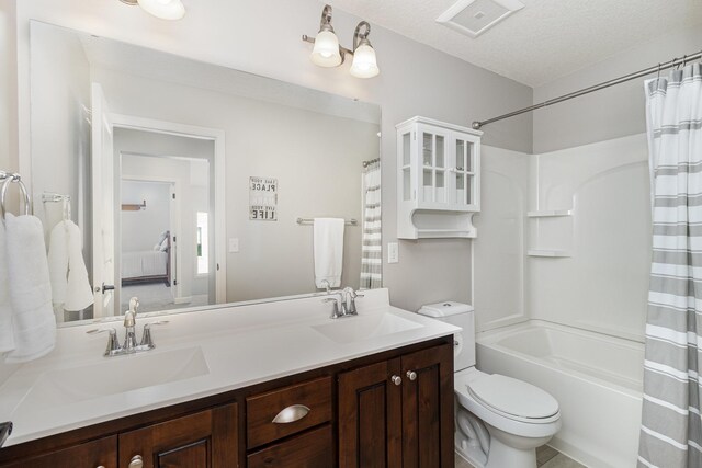 bathroom featuring double vanity, toilet, and shower / tub combo