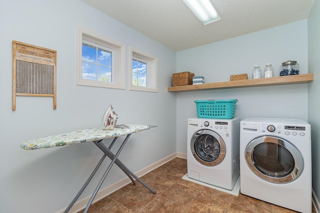 clothes washing area featuring washing machine and clothes dryer and baseboards