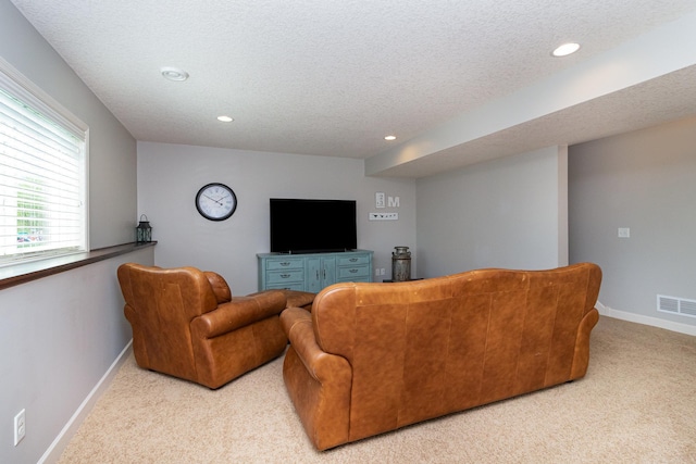 living room with carpet flooring, recessed lighting, baseboards, and a textured ceiling