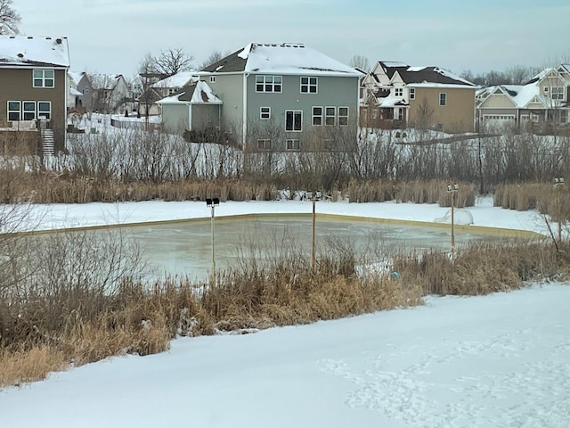 yard covered in snow featuring a residential view