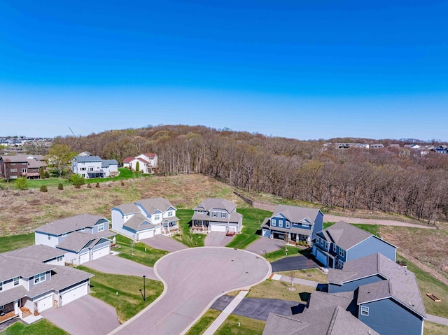 birds eye view of property with a forest view and a residential view
