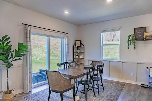 dining space featuring recessed lighting, wood finished floors, visible vents, and a wainscoted wall