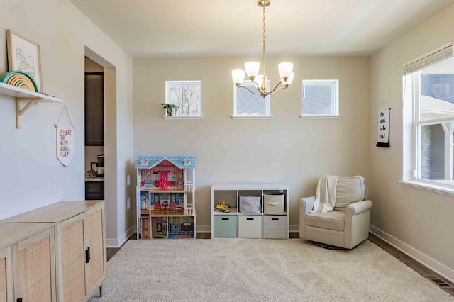 rec room featuring baseboards, an inviting chandelier, and visible vents