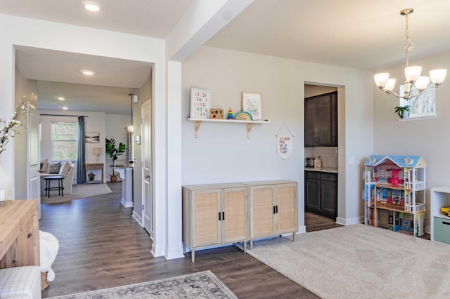 interior space with an inviting chandelier, baseboards, recessed lighting, and dark wood-type flooring