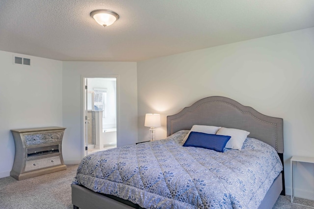 carpeted bedroom featuring connected bathroom and visible vents