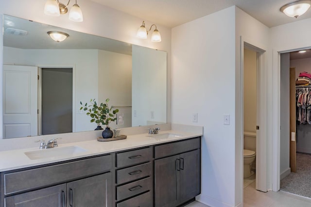 full bath with a sink, baseboards, and double vanity