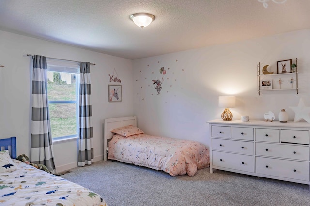 bedroom with a textured ceiling and light carpet