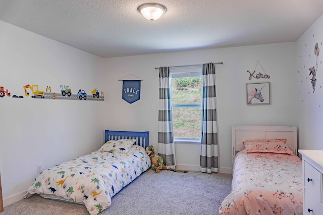 bedroom with carpet flooring, a textured ceiling, and baseboards