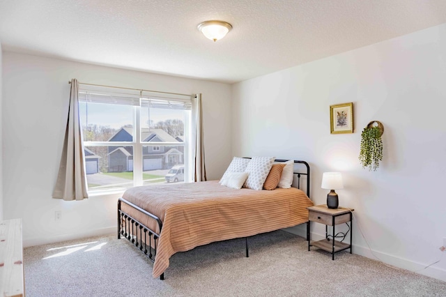 carpeted bedroom with baseboards