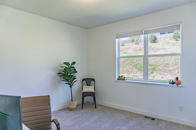 sitting room with baseboards, visible vents, and carpet